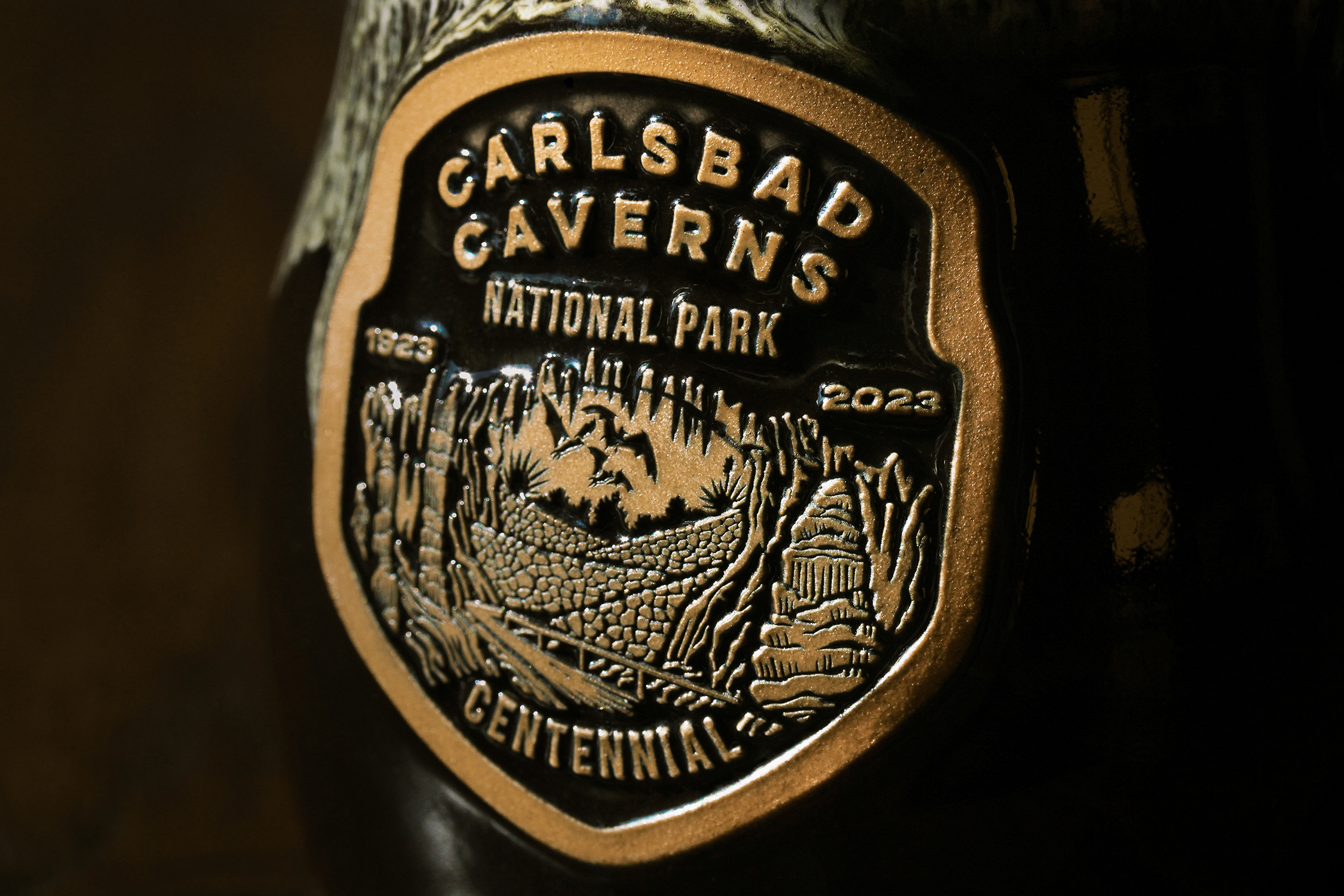 Carlsbad Caverns Centennial Logo badge bats branding carlsbad caverns cave coffee design digital emblem illustration logo merch merchandise mug national park nature new mexico painting typography vintage
