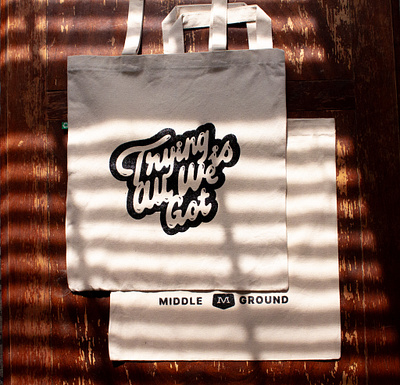 Trying Is All We Got: Tote Bags badge badge design branding cream design iconography illustration logo merch motion graphics product tote bag typography ui