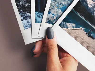 Hand Holding Fan of Four Instant Photos Mockup branding graphic design hand holiday instant photo mockup